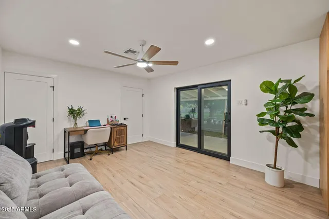 a living room with furniture and a wooden floor