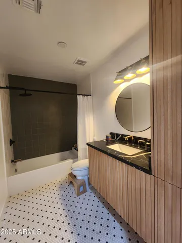 a bedroom with a bed and a large mirror