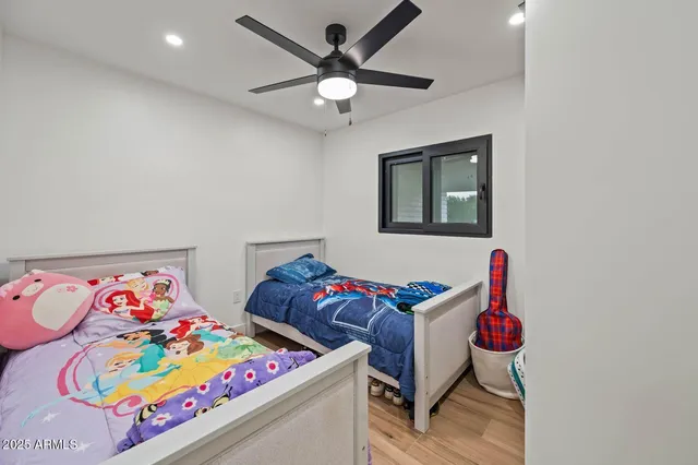 a view of a patio with table and chairs near a barbeque