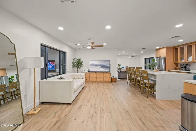 a living room with furniture and a wooden floor