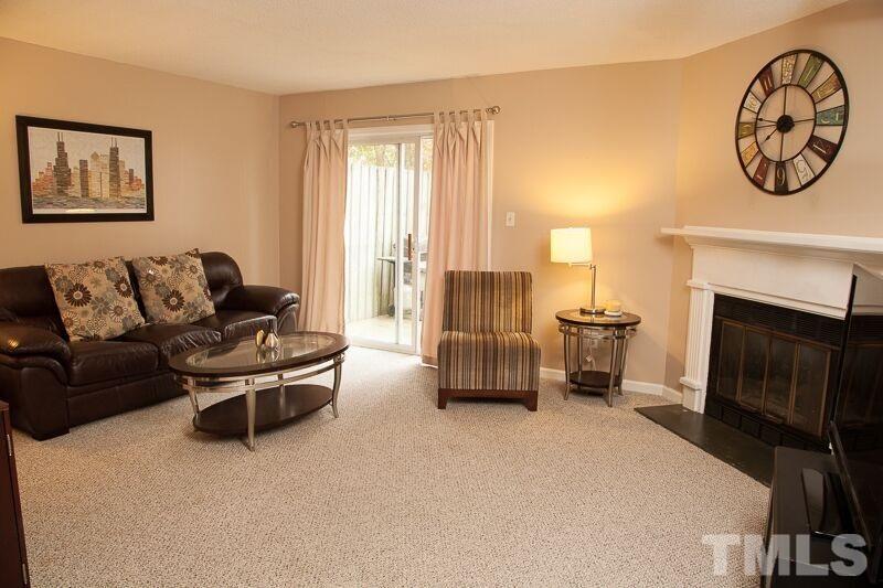 6603 Orford Court Raleigh, NC 27615 - Photo 1 of 14 a living room with furniture and a fireplace
