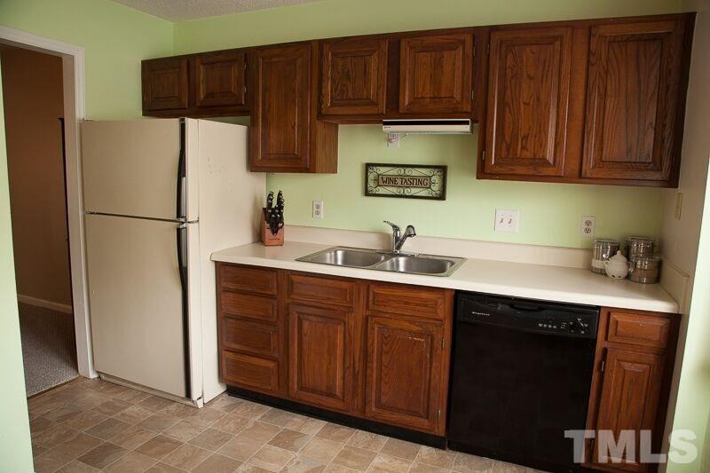 6603 Orford Court Raleigh, NC 27615 - Photo 3 of 14 a kitchen with a sink cabinets and stainless steel appliances