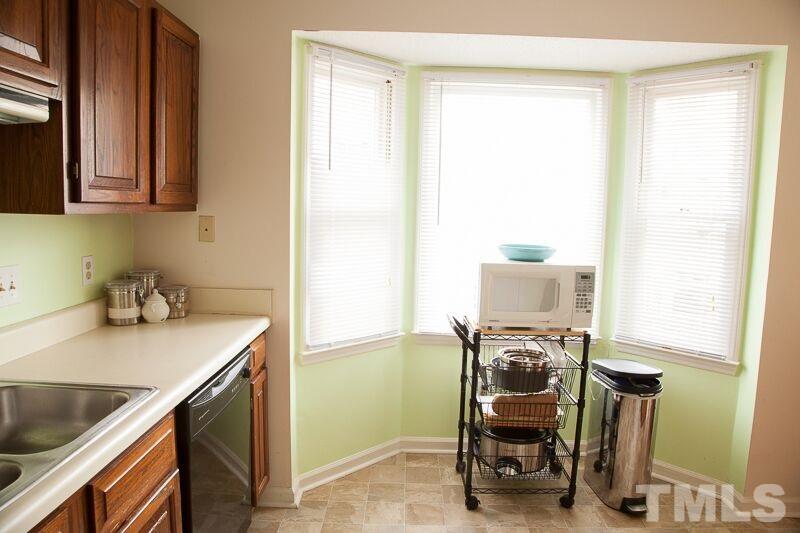 6603 Orford Court Raleigh, NC 27615 - Photo 4 of 14 a room with a chair and a stove next to a window