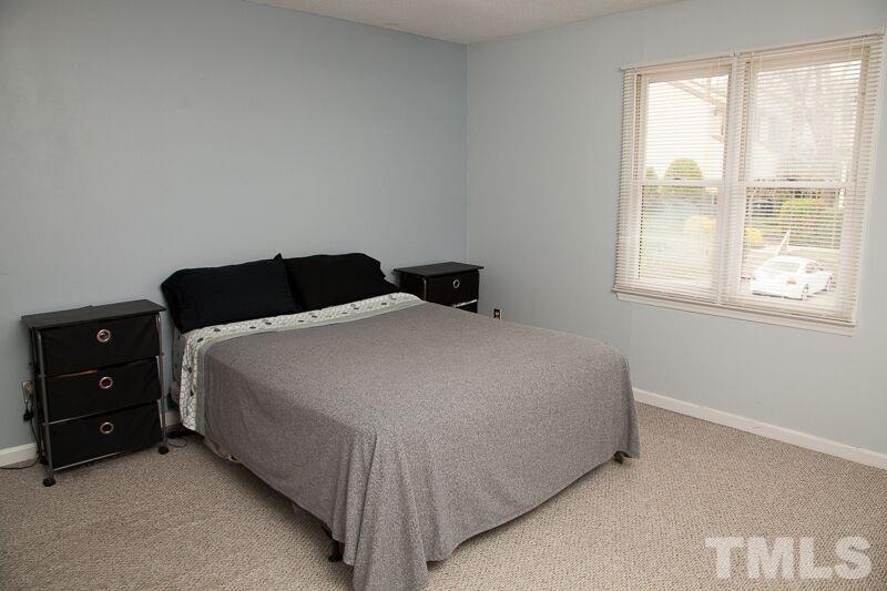 6603 Orford Court Raleigh, NC 27615 - Photo 7 of 14 a bedroom with a bed and a window