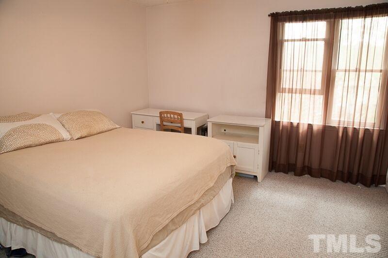 6603 Orford Court Raleigh, NC 27615 - Photo 8 of 14 a spacious bedroom with a bed and a window