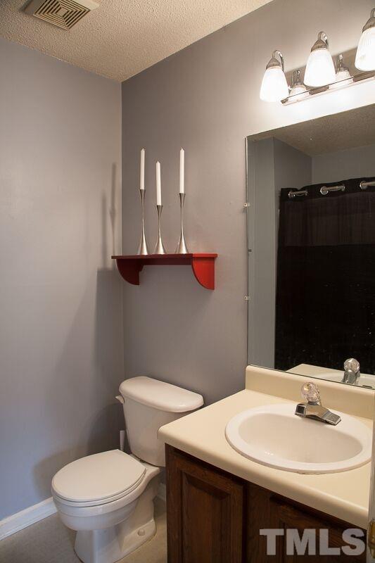 6603 Orford Court Raleigh, NC 27615 - Photo 10 of 14 a bathroom with a sink a toilet and mirror