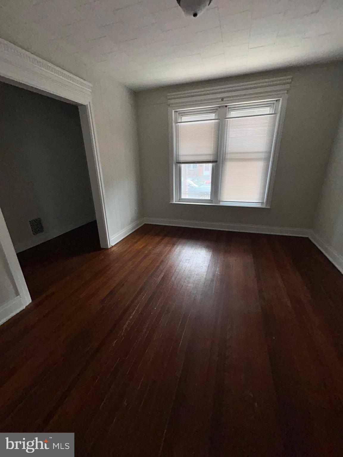 53 Lehman Street, Unit 1 Lebanon, PA 17046 - Photo 7 of 7 an empty room with wooden floor and windows