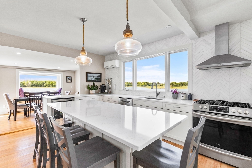 34 Cliff Road Hingham, MA 02043 - Photo 7 of 24 a kitchen with kitchen island stainless steel appliances a dining table and chairs