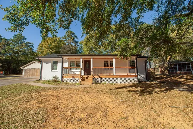 a house view with a sitting space and garden