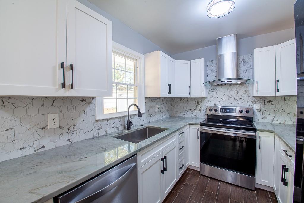 13 Shadow Lane Cartersville, GA 30120 - Photo 19 of 36 a kitchen with granite countertop white cabinets sink and stainless steel appliances