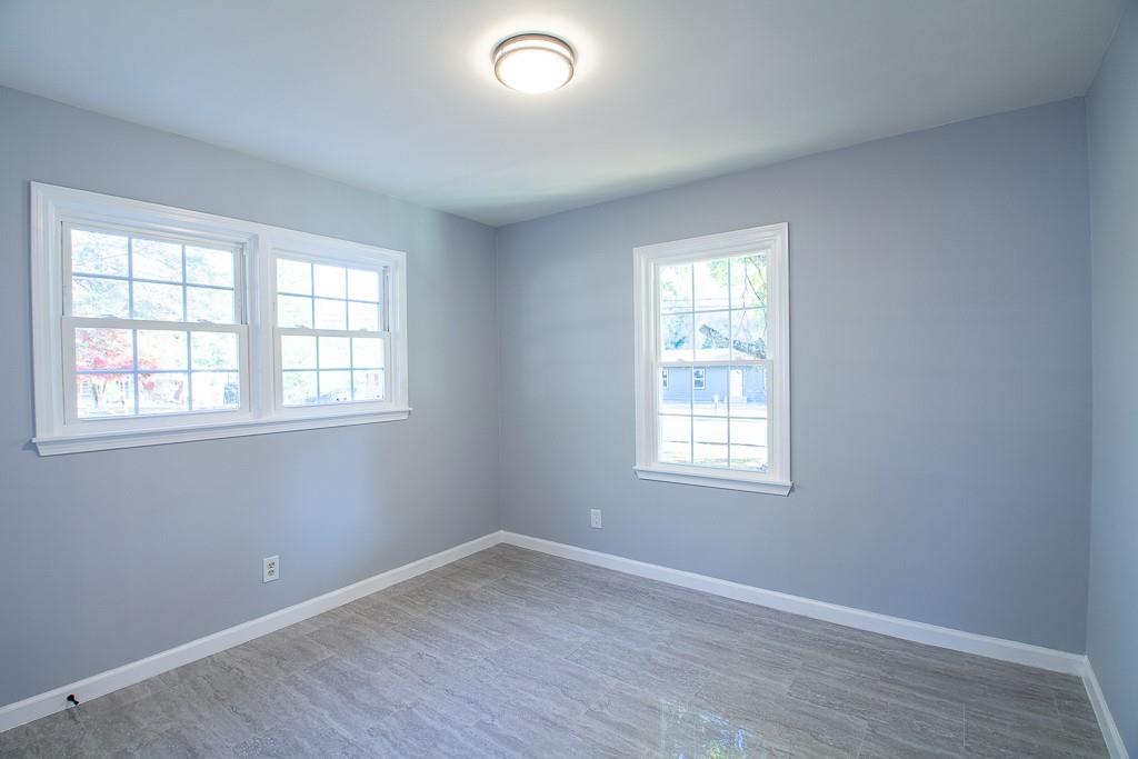 13 Shadow Lane Cartersville, GA 30120 - Photo 32 of 36 an empty room with wooden floor and windows