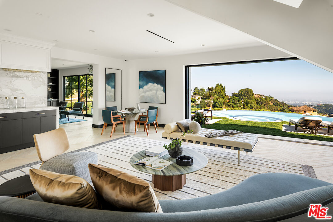 10932 Savona Road Los Angeles, CA 90077 - Photo 12 of 72 a living room with furniture and a flat screen tv