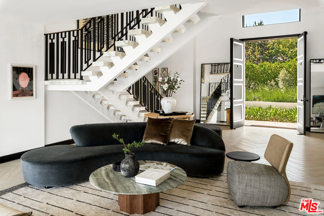 10932 Savona Road Los Angeles, CA 90077 - Photo 15 of 72 a living room with furniture and a large window