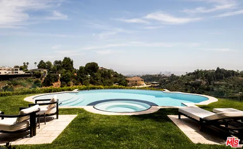 aerial view of a house with swimming pool garden and lake view