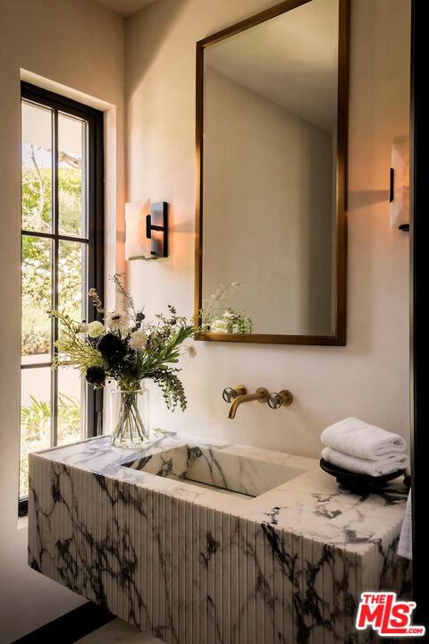 10932 Savona Road Los Angeles, CA 90077 - Photo 32 of 72 a bathroom with a granite countertop sink and a mirror