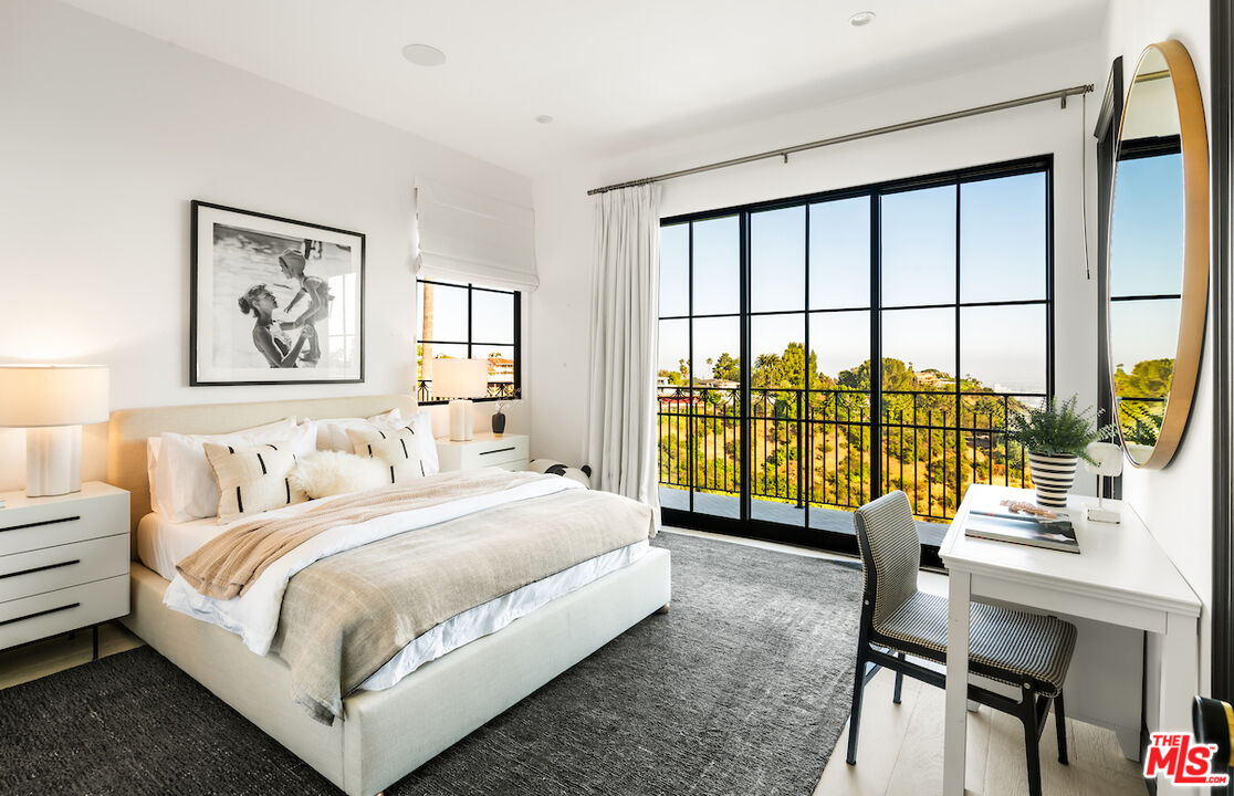 10932 Savona Road Los Angeles, CA 90077 - Photo 52 of 72 a bedroom with a large bed and a large window