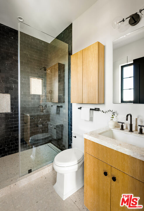 10932 Savona Road Los Angeles, CA 90077 - Photo 53 of 72 a bathroom with a sink a toilet and shower