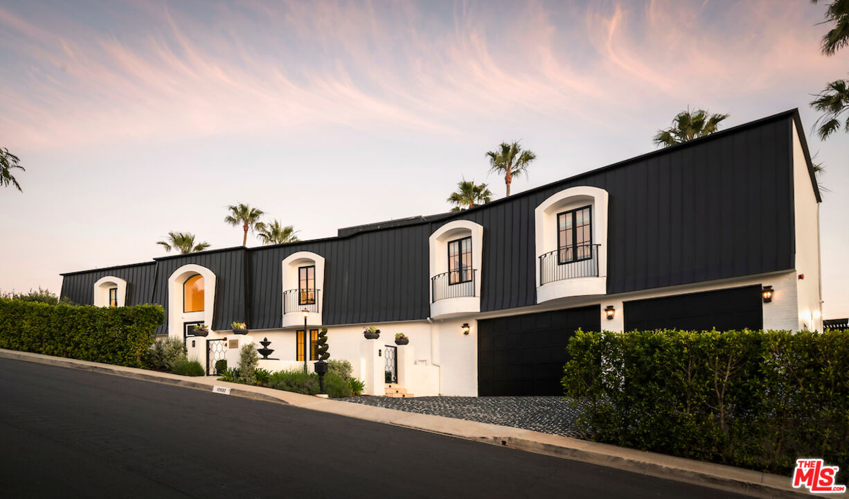 10932 Savona Road Los Angeles, CA 90077 - Photo 66 of 72 a front view of a house with a yard
