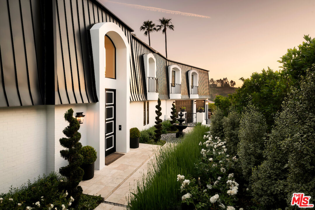 10932 Savona Road Los Angeles, CA 90077 - Photo 67 of 72 a front view of a house with a yard