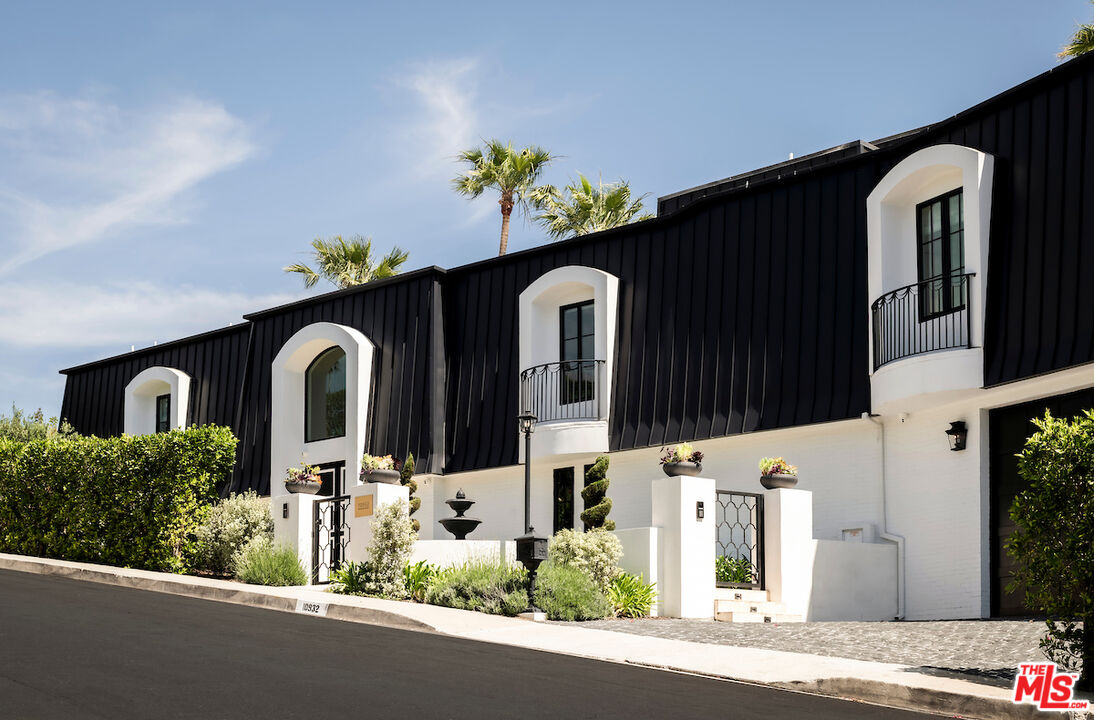 10932 Savona Road Los Angeles, CA 90077 - Photo 7 of 72 a front view of a house with a yard