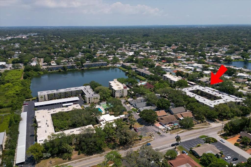 11485 Oakhurst Road, Unit 200321 Largo, FL 33774 - Photo 22 of 28 an aerial view of residential houses with outdoor space and lake view