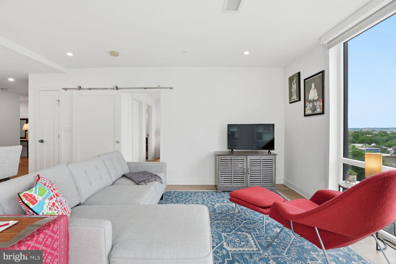 37 L Street Southeast, Unit 902 Washington, DC 20003 - Photo 12 of 43 a living room with furniture and a flat screen tv
