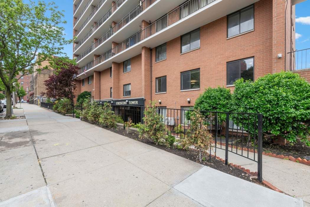 23-22 30th Road, Unit 10H Queens, NY 11102 - Photo 14 of 16 a front view of a building with garden
