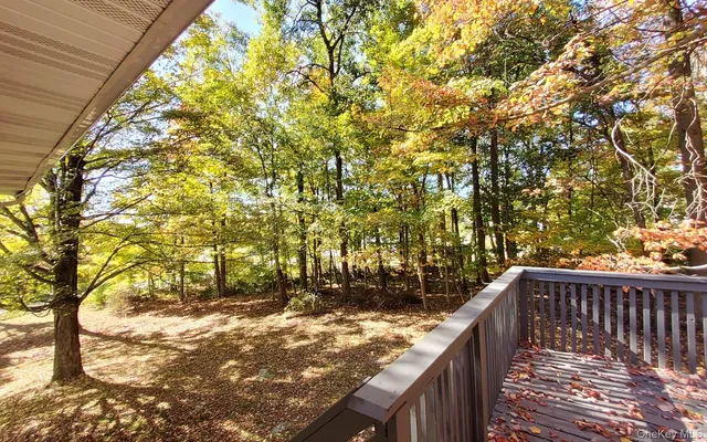 a view of balcony with wooden floor and fence