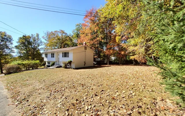a backyard of a house with large trees
