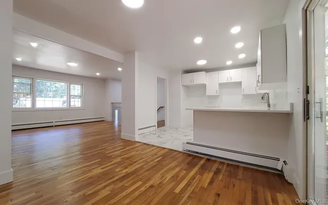 a view of kitchen and hall with wooden floor