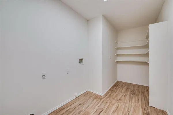 a view of a room with wooden floor