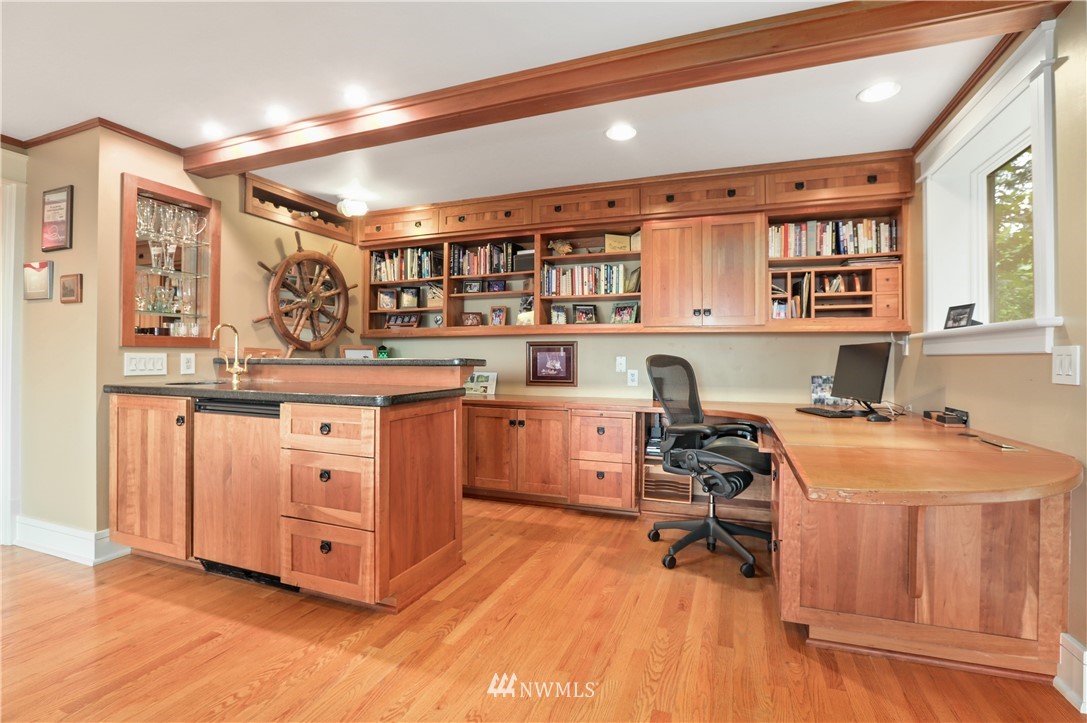 711 Briar Road Bellingham, WA 98225 - Photo 28 of 40 a view of a kitchen with kitchen island a stove a sink wooden floor and cabinets