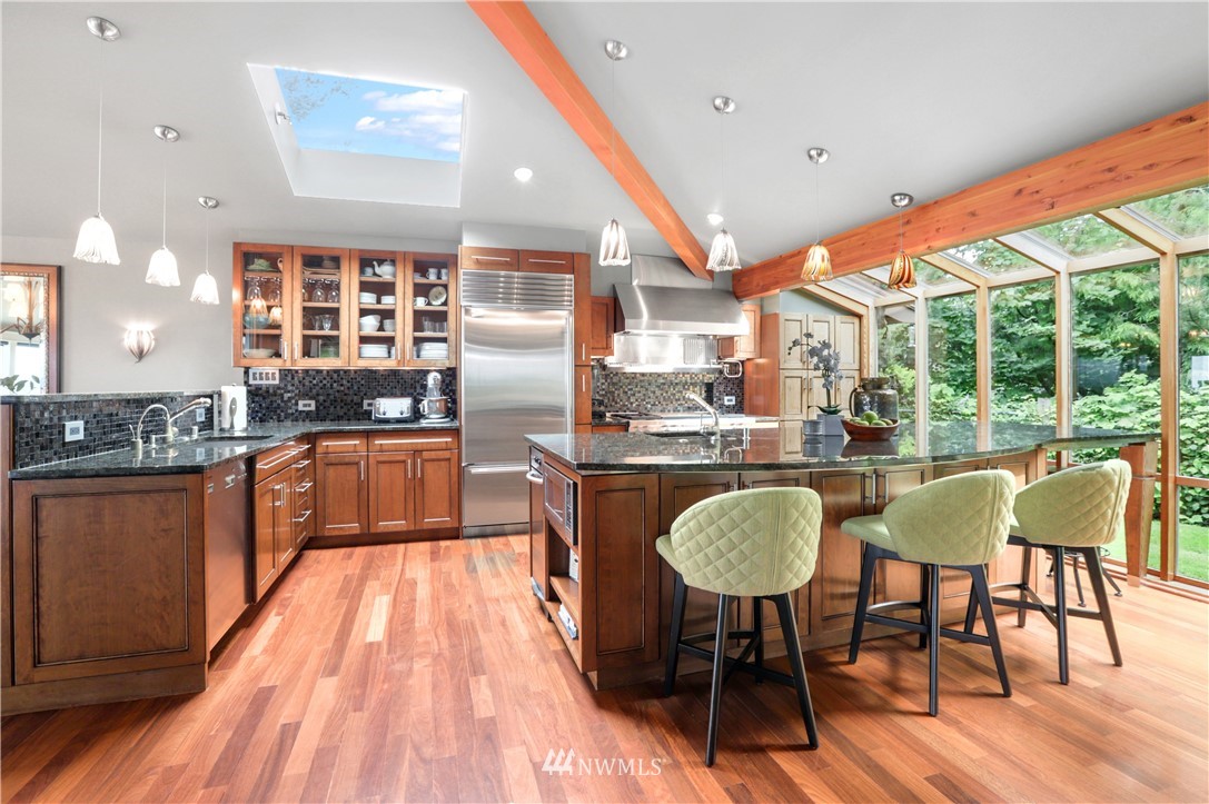 711 Briar Road Bellingham, WA 98225 - Photo 5 of 40 a kitchen with stainless steel appliances granite countertop a table chairs stove and a kitchen view