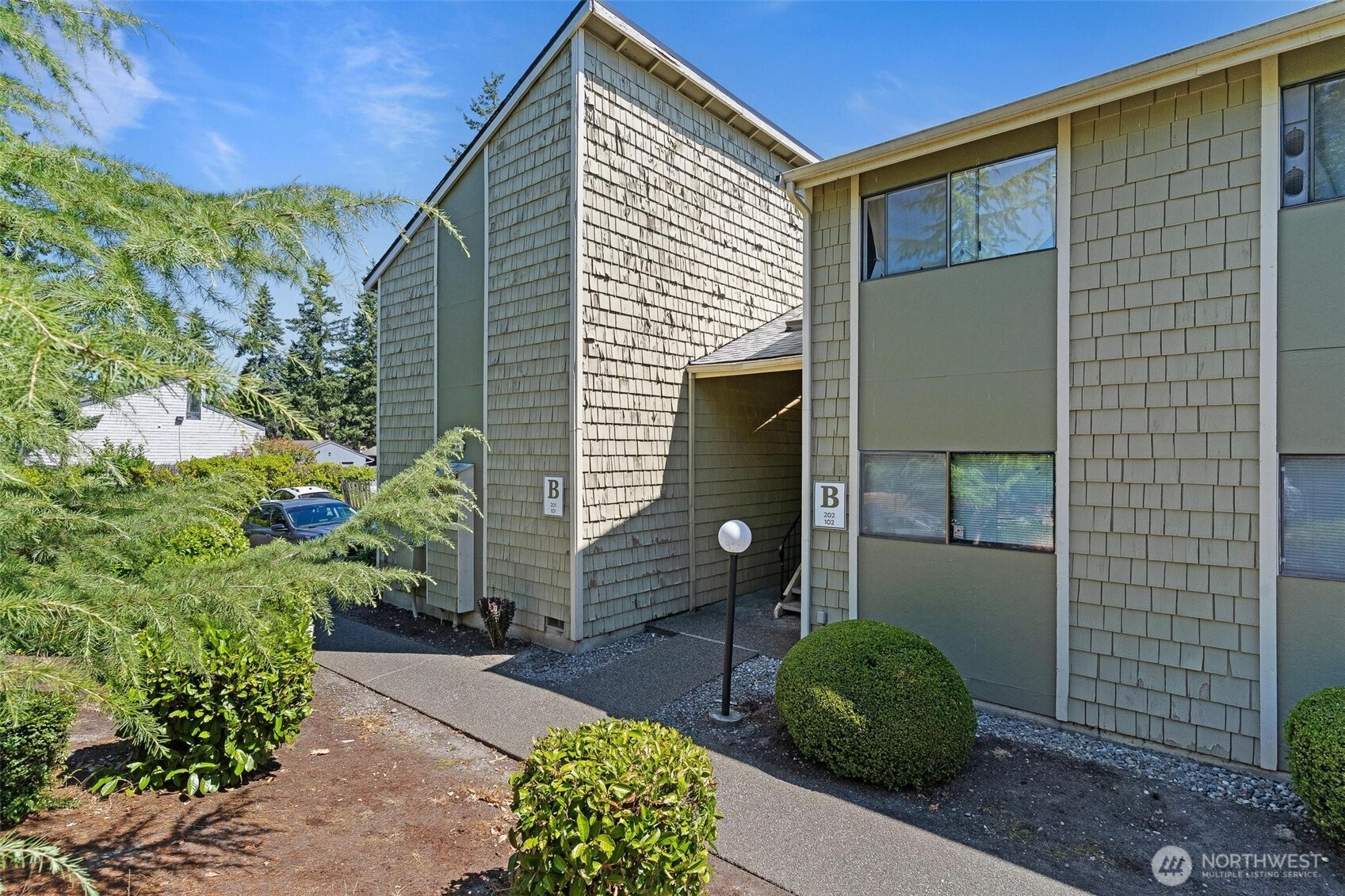2020 Grant Avenue South, Unit B201 Renton, WA 98055 - Photo 20 of 20 a front view of a house with garden