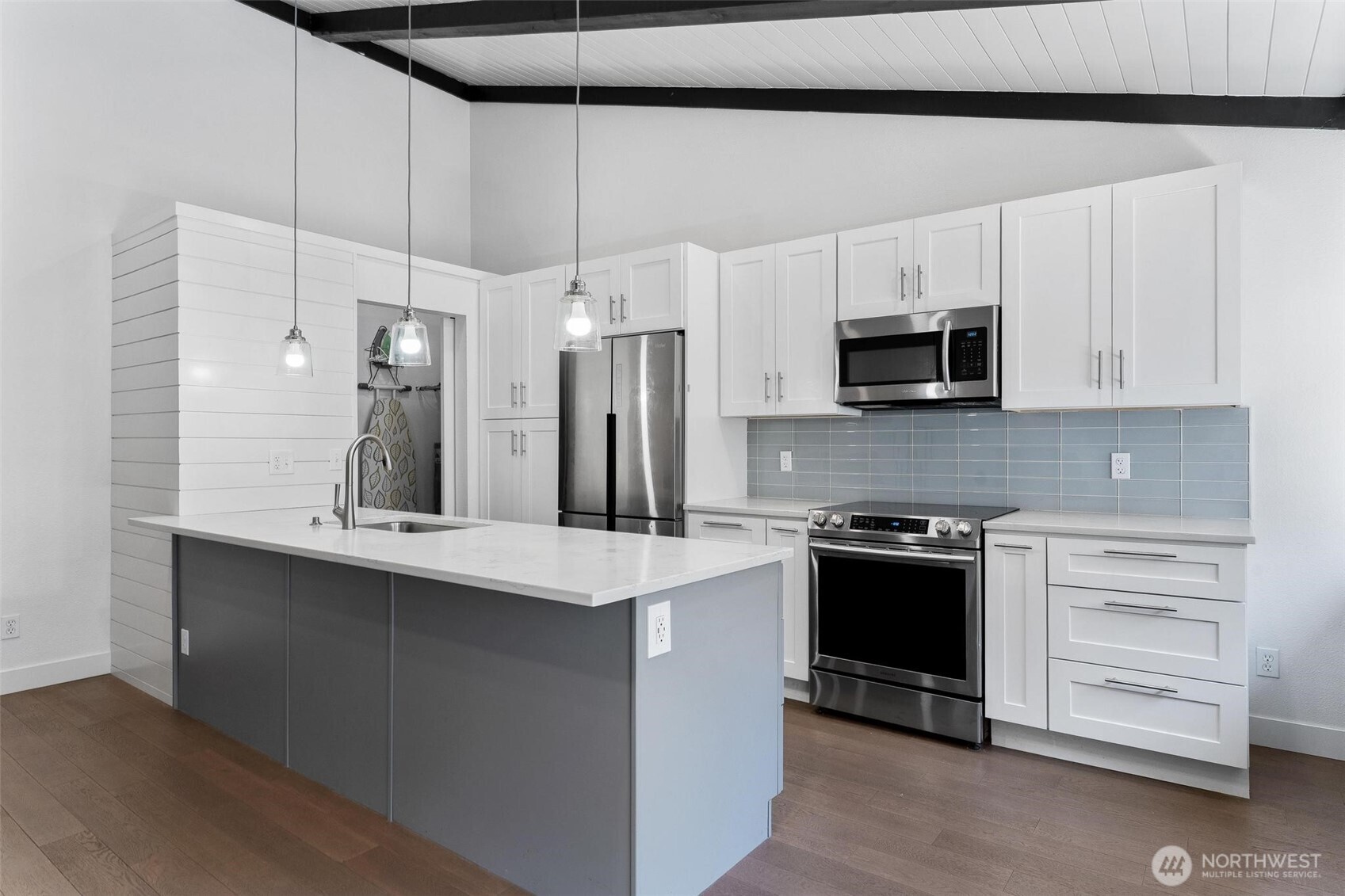 2020 Grant Avenue South, Unit B201 Renton, WA 98055 - Photo 4 of 20 a kitchen with stainless steel appliances a stove sink microwave and cabinets