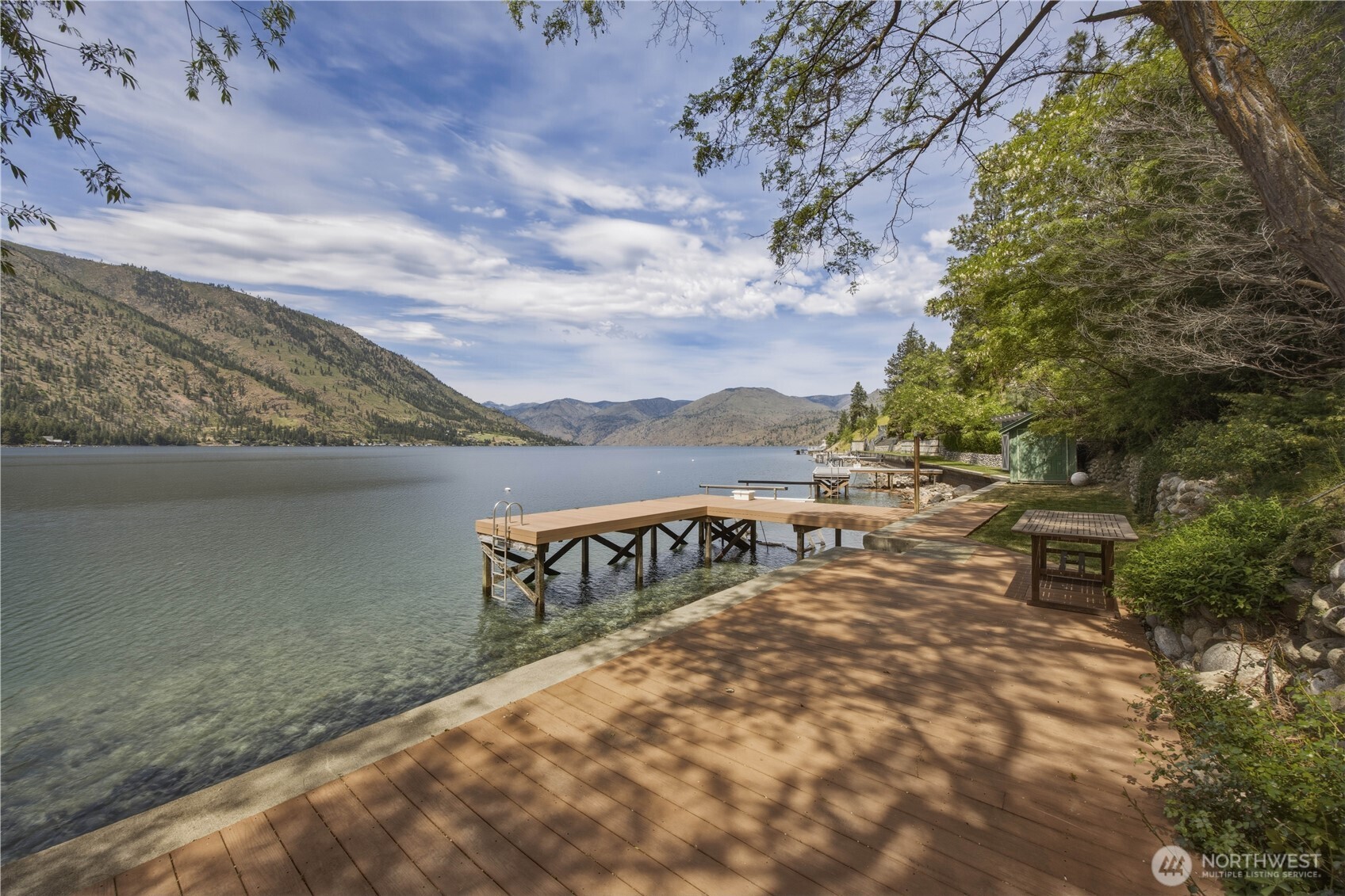 141 Sunset Place Manson, WA 98831 - Photo 1 of 38 a view of a terrace with a bench
