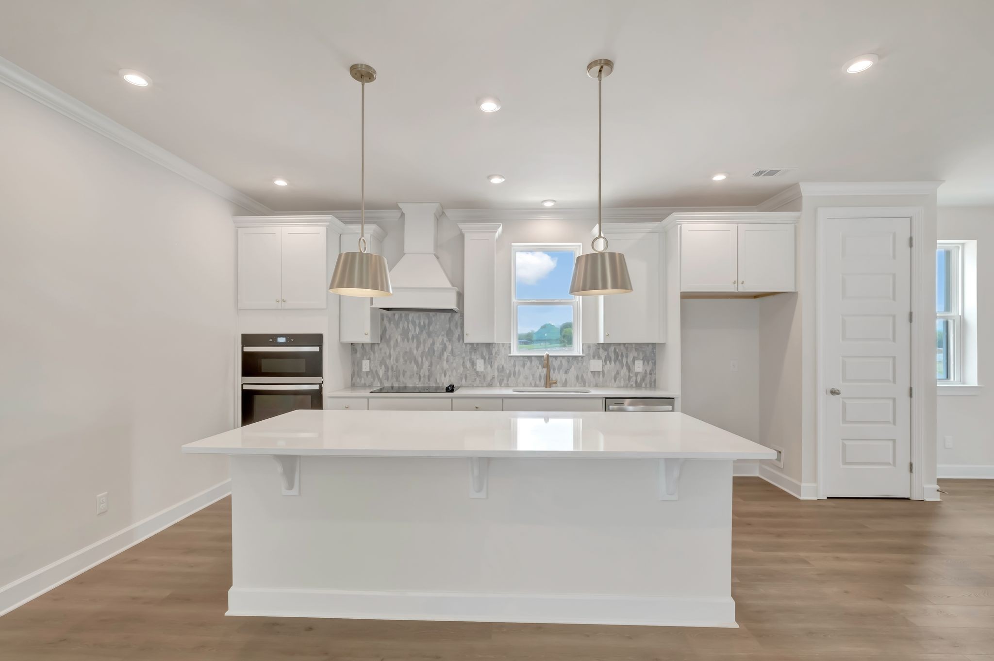 1109 Codah Drive Mount Juliet, TN 37122 - Photo 5 of 19 a large kitchen with granite countertop a large center island a sink stainless steel appliances and cabinets
