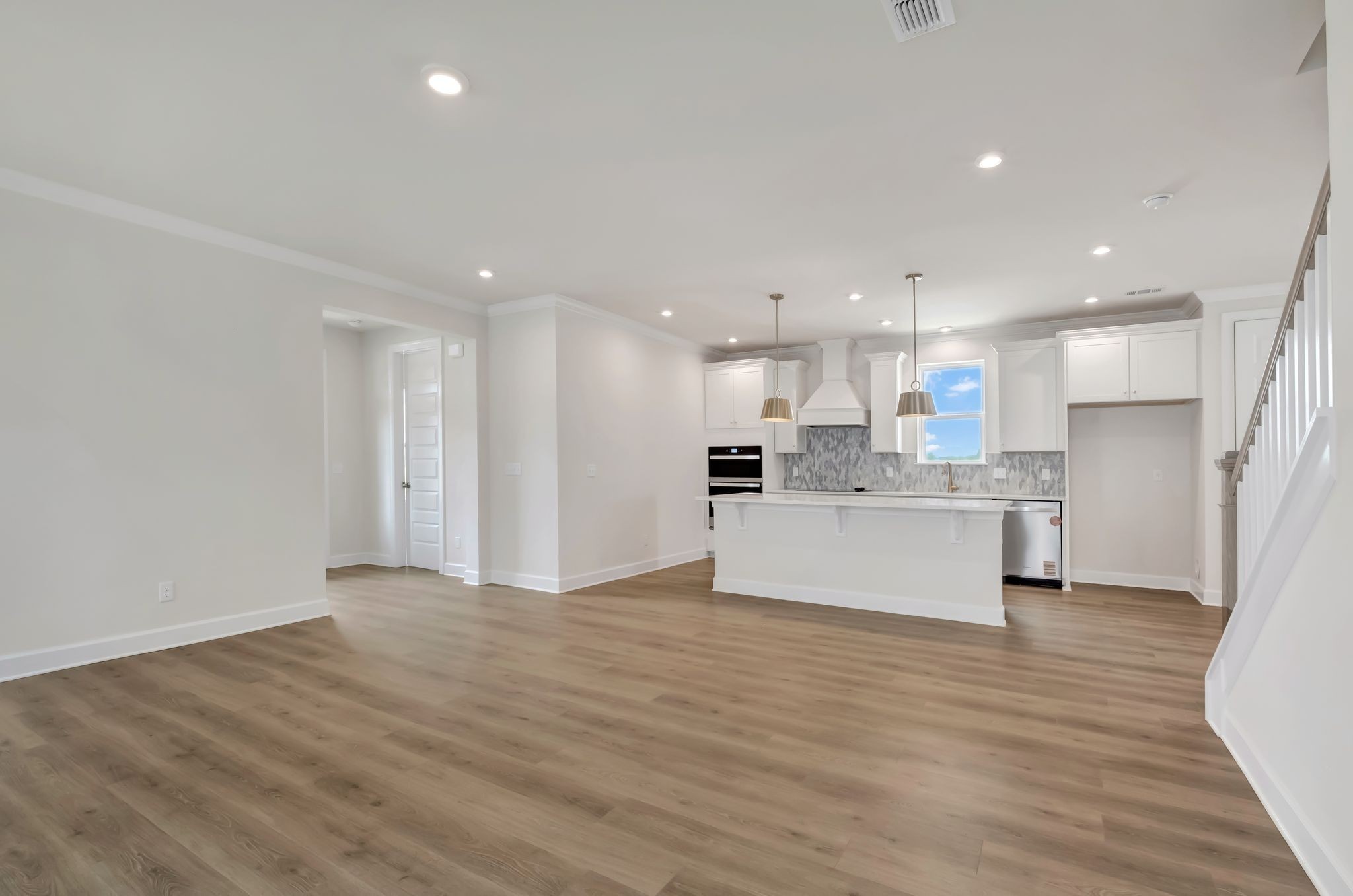 1109 Codah Drive Mount Juliet, TN 37122 - Photo 8 of 19 a view of kitchen with kitchen island a sink dishwasher a refrigerator and white cabinets with wooden floor