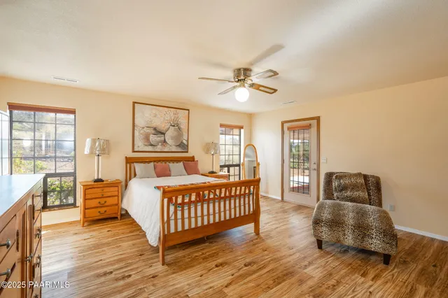 a large bed sitting in a bedroom next to a window