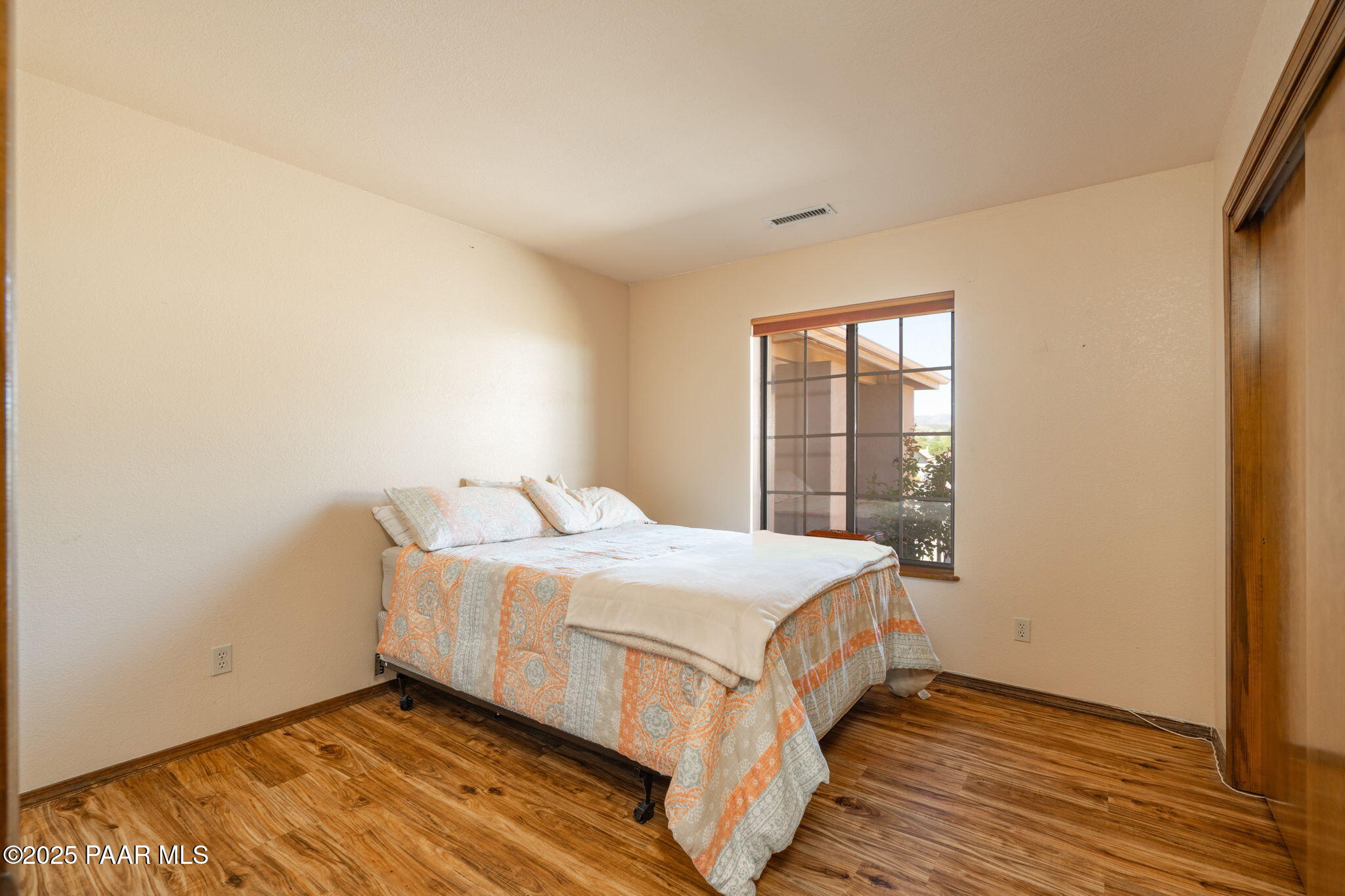 11992 Rawhide Ridge Dewey, AZ 86327 - Photo 18 of 46 a large bed sitting in a bedroom next to a window
