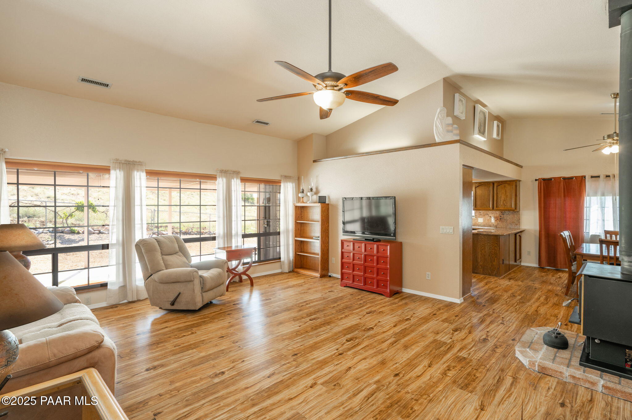 11992 Rawhide Ridge Dewey, AZ 86327 - Photo 4 of 46 a living room with furniture a flat screen tv and a floor to ceiling window
