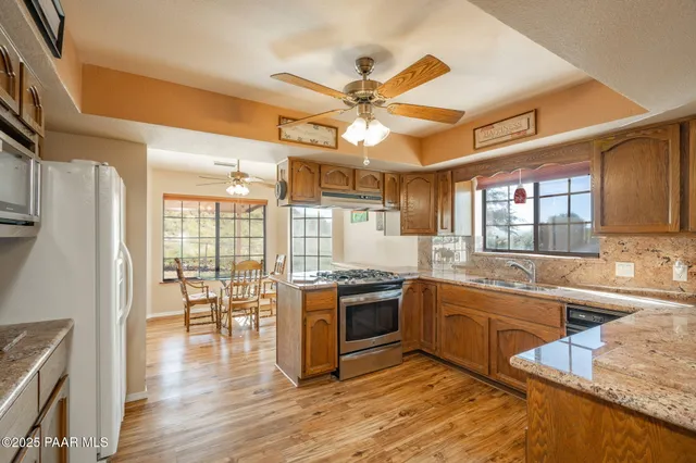 a kitchen with stainless steel appliances granite countertop a stove a refrigerator and a stove