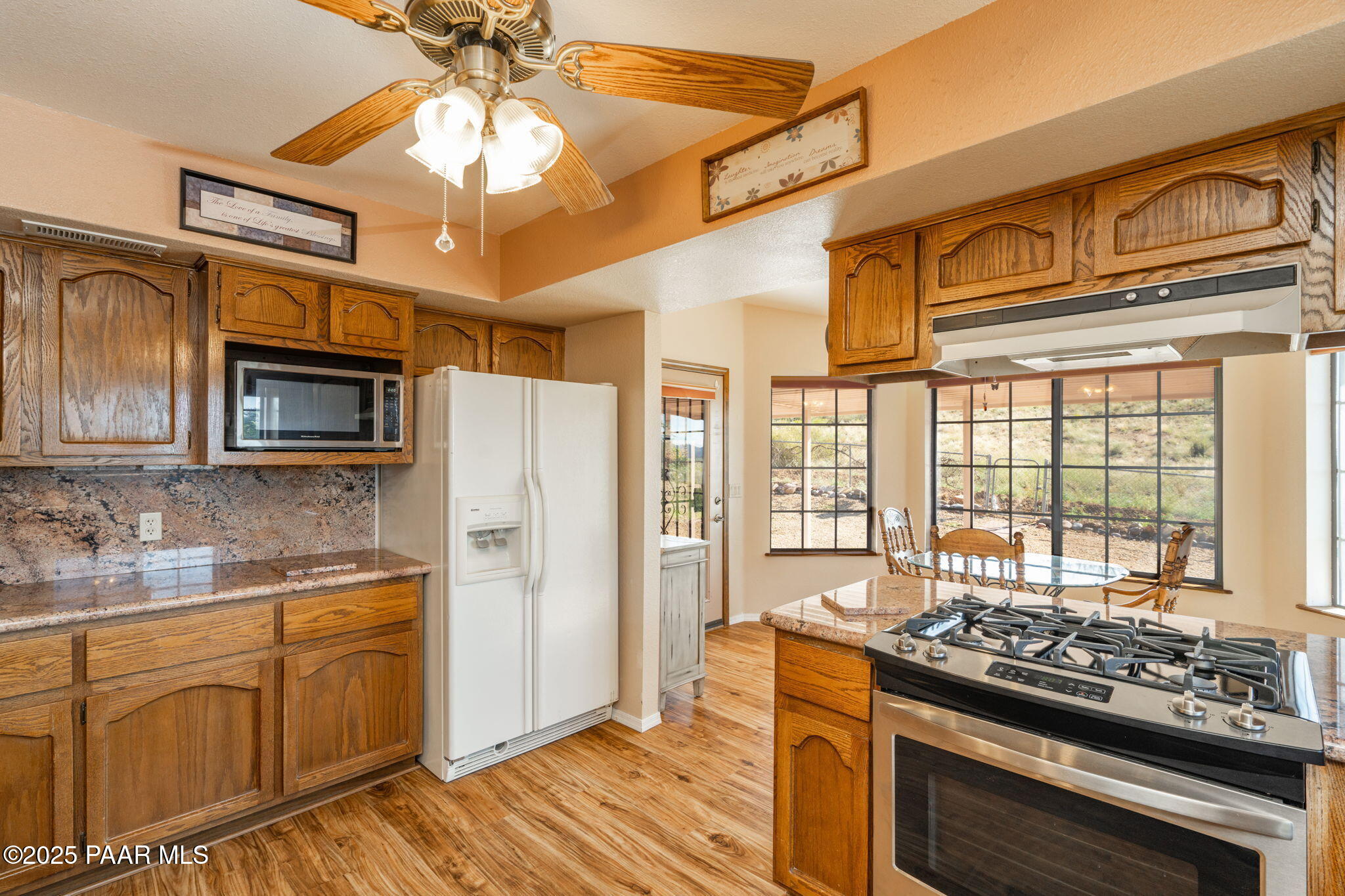 11992 Rawhide Ridge Dewey, AZ 86327 - Photo 10 of 46 a kitchen with stainless steel appliances granite countertop a stove a refrigerator and a stove