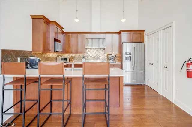 a kitchen with stainless steel appliances kitchen island granite countertop a table and chairs