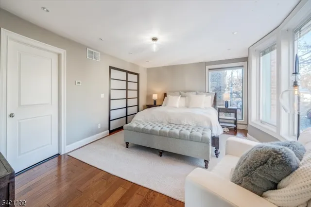 a bedroom with a bed couch and window