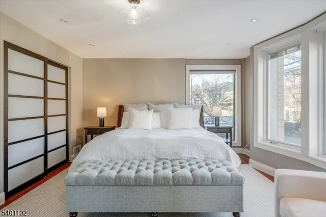 a bedroom with a large bed and a window