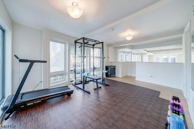 a view of a room with gym equipment and a large window