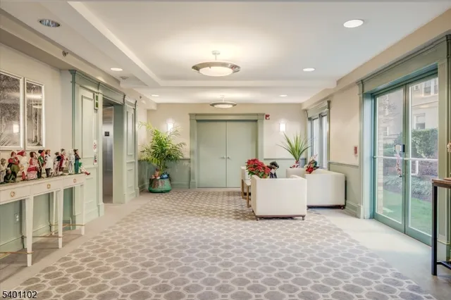 a white building with glass door and furniture
