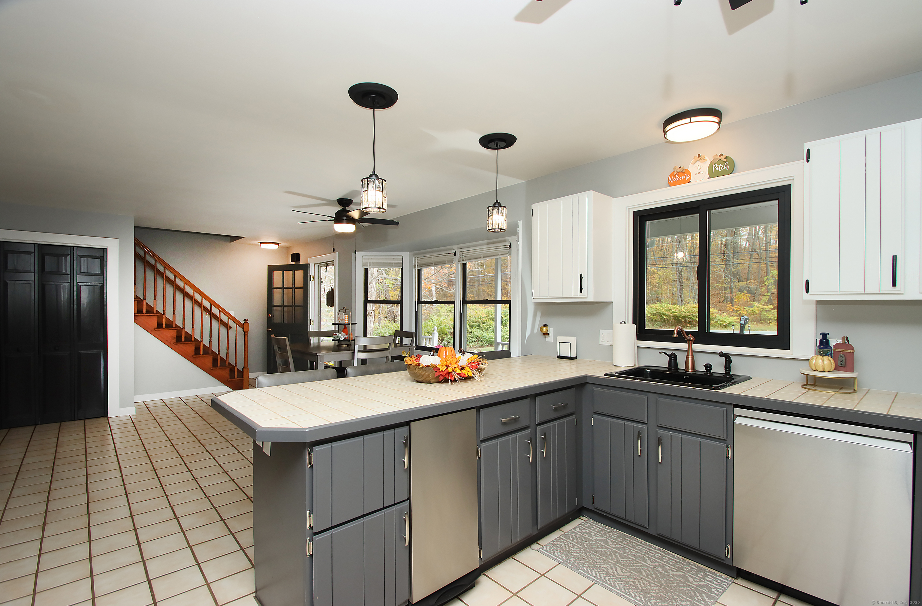 821 Essex Road Westbrook, CT 06498 - Photo 13 of 40 a kitchen with a sink a window and appliances