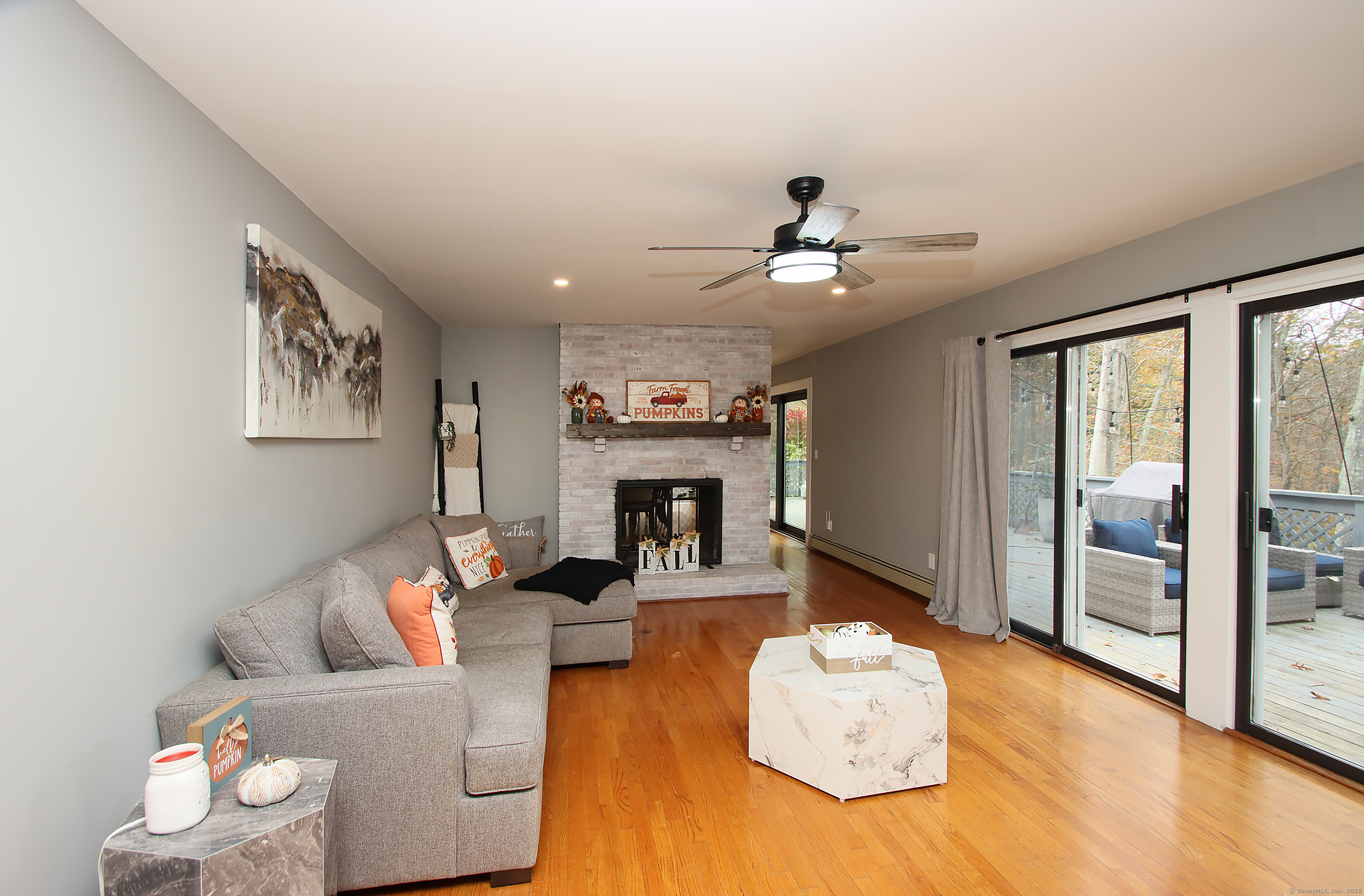 821 Essex Road Westbrook, CT 06498 - Photo 16 of 40 a living room with furniture and a fireplace